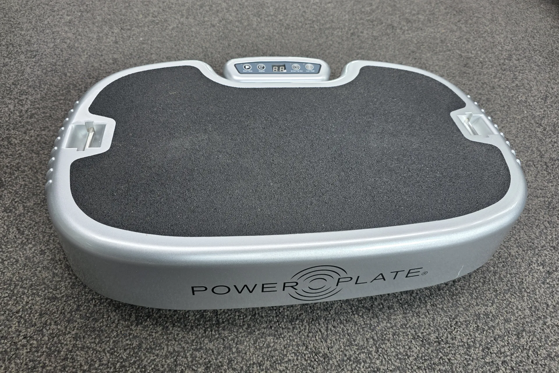 Silver Power Plate Personal vibration plate on carpet