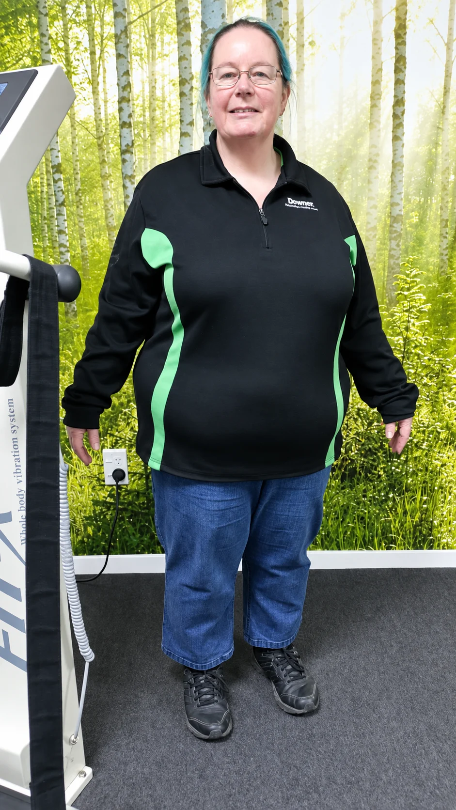 Supplied portrait of a woman standing beside a vibration-training machine