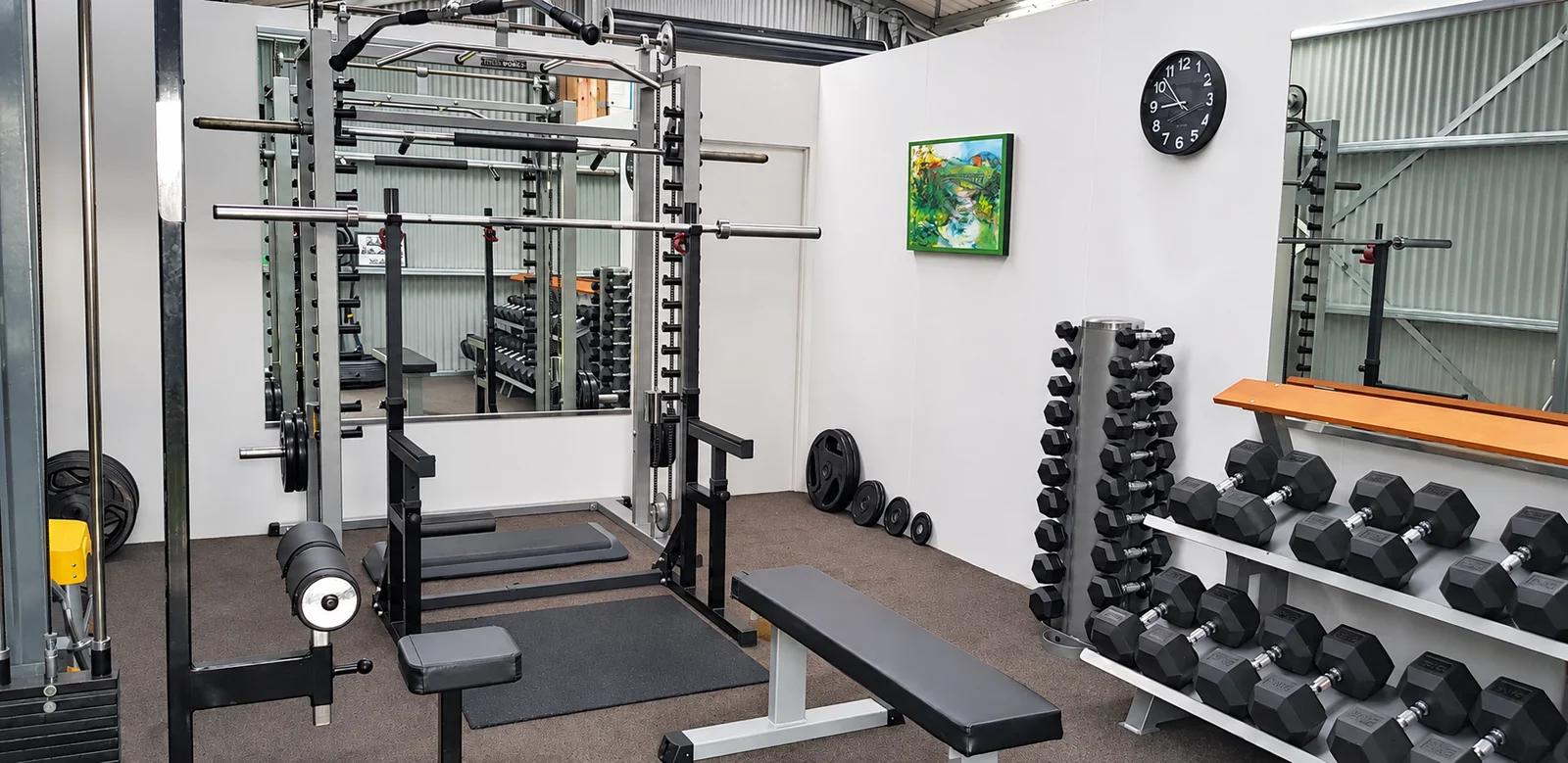 Weight-training equipment, benches and dumbbells in the supplied Marty’s Gym image